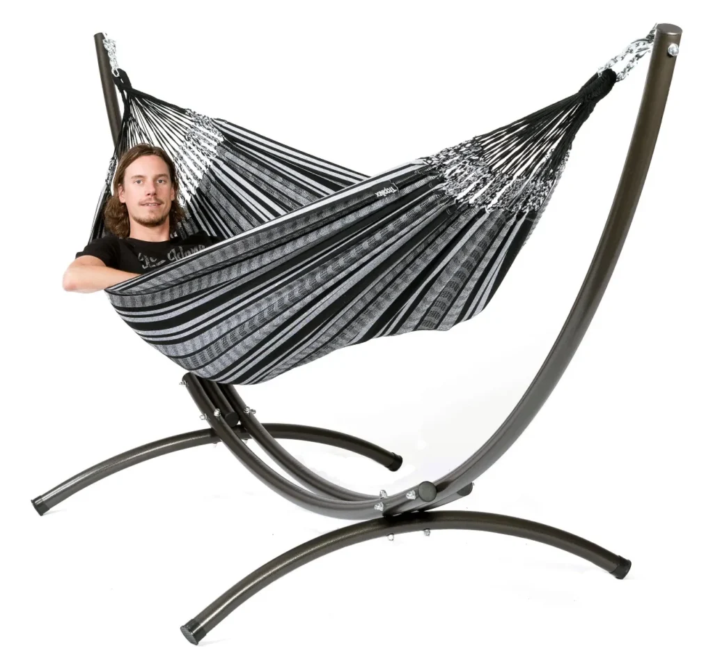 Person relaxing in a hammock in a peaceful outdoor garden